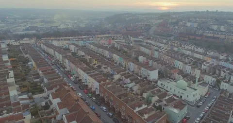 Aerial pulling back over rows of picturesque coloured terrace English houses and Stock Footage 108048774