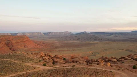 Aerial-Pulling back over rugged rock formation at sunset Stock Footage 117617231