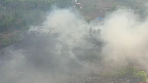 Aerial Pulling Back Revealing Burning Farmland, Indonesia Stock Footage 142509456