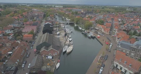 Aerial pulling back from sailing boats to reveal the Drommedaris Defence tower 스톡 동영상 108045153