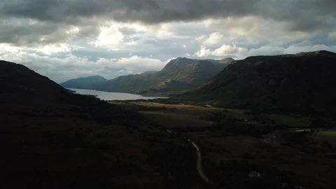 Aerial Pulling Back Through Dramatic Scottish Landscape At Sunset Stock Footage 125181829