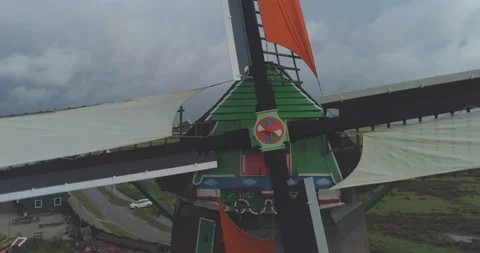 Aerial pulling out from spinning colourful blades of traditional historic Dutch Video stock 108046161