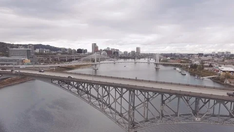 Aerial pulls up and away from Ross Island Bridge to reveal Portland downtown Stock Footage 94098227