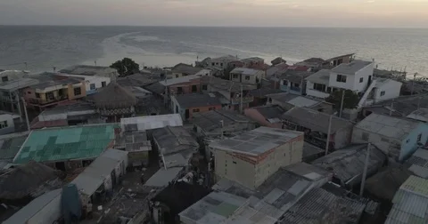Aerial pulls back from above the cramped island of Santa Cruz del Islote at dusk Stock-Footage 83801590