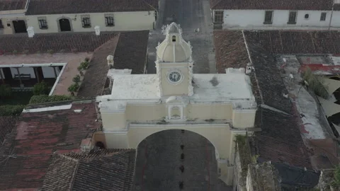 Aerial pulls back from Arco Santa Catalina and tilts up to reveal Volcan Agua Vídeos de archivo 167987255