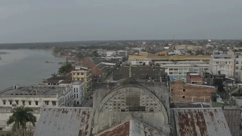 Aerial pulls back between steeples and tilts down to reveal church in Quibdo 스톡 동영상 106369264