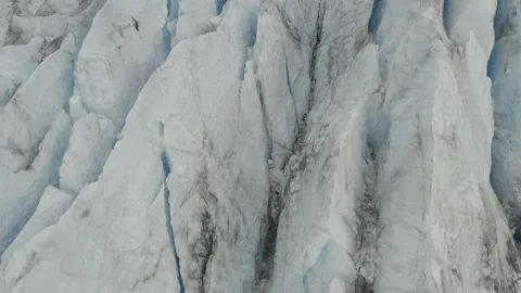Aerial pulls back from crevasses and tilts up to reveal the Knik glacier 스톡 동영상 159264575