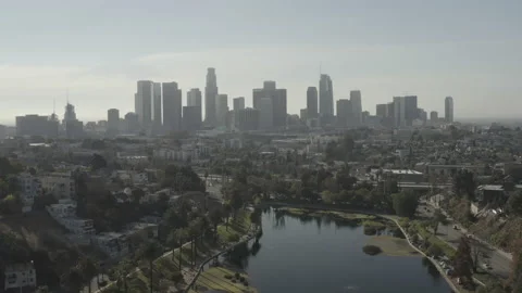 Aerial pulls back from downtown Los Angeles skyline to reveal Echo Park lake Vídeos de archivo 150705429