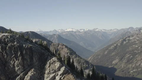 Aerial pulls back over ridge from the mountains in North Cascades, Washington Stock Footage 345176376