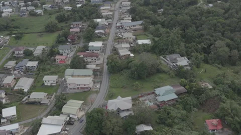 Aerial pulls back from road to reveal landscape in southern Trinidad at dusk Vídeos de archivo 261906836