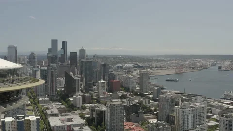 Aerial pulls back from the Seattle skyline and Mt Rainier to reveal Space Needle Video stock 158819139