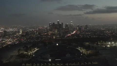 Aerial pulls back from skyline of downtown Los Angeles to reveal Dodger Stadium Vídeos de archivo 150685072