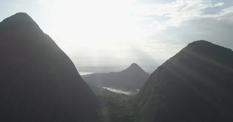 Aerial pulls back slowly to reveal the silhouettes of the Cerros de Mavecure Видео 100656392