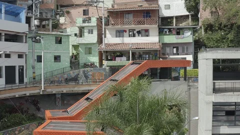Aerial pulls back from tight on the orange escalators of Comuna 13 in Medellin 스톡 동영상 105642963