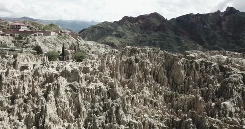 Aerial pulls back from tight on rock formations to reveal the Valle de la Luna Video stock 87521111