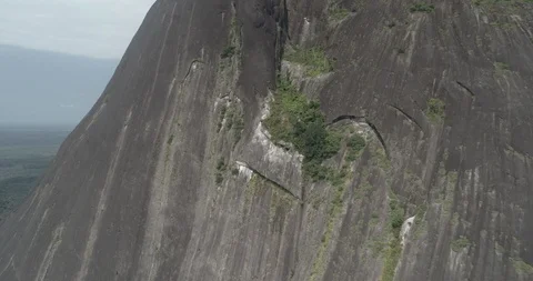Aerial pulls back from the window to reveal the whole Cerro Pajarito mountain 스톡 동영상 100496672