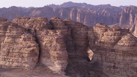 Aerial push back of rock formation and palm orchard, during sunrise, 4K Stock Footage 196808397