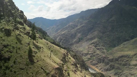 Aerial push in to canyon hillside in Hells Canyon Idaho above Snake River Stock Footage 243998368
