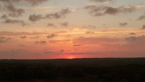 Aerial push forward as sun dips below horizon over forest Oklahoma 스톡 동영상 332963262