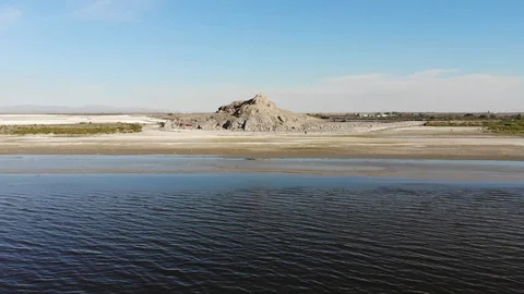 Aerial Push Into a Hill Over a Large Body of Water Video stock 119941214