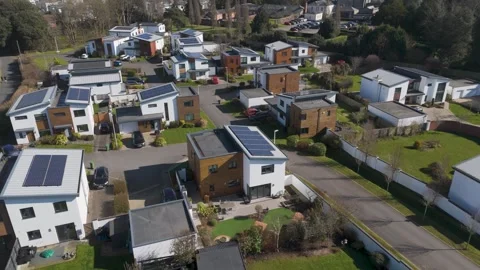 Aerial push-in over high-spec neighborhood of angular modern homes with solar Stock Footage 310596783