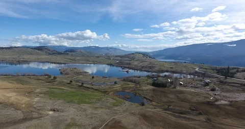 Aerial push of rural cattle ranch nestled in mountains Stock Footage 88455462