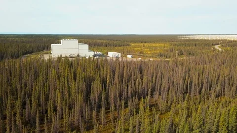 Aerial push shot over forest in Alaska towards HAARP research facility 4k Stock Footage 115486072