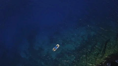 Aerial Push In Top View Lone Boat Anchored In The Ocean. Stock Footage 95804331