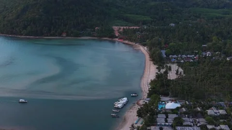 Aerial Push In Toward Beach Resort and Speedboats at Tropical Coast Stock Footage 336389869