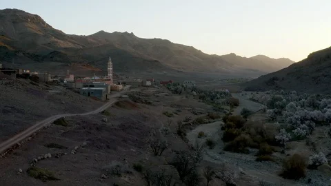 An aerial push towards a mosque in a small village at sunrise. Stock Footage 127018989