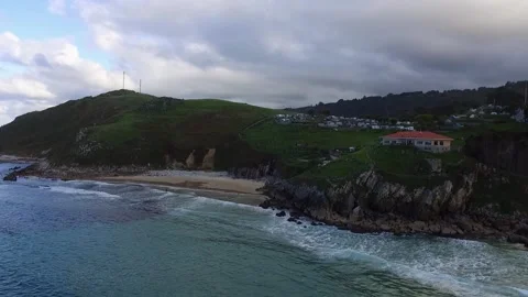 Aerial push-in Vidiago beach cliff and campsite, Llanes, Asturias, Spain. Stock Footage 255266318