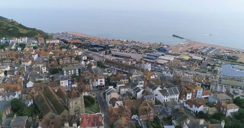 Aerial push in view of the old town of Hastings in England and the beach Stock-Footage 79927691
