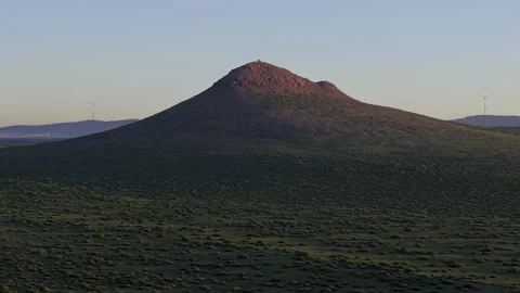 Aerial Push In to Volcanic Cone and Wind Turbines at Twilight 4K HLG Stock Footage 343802066