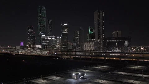 Aerial Push Zoom In Toward KAFD Skyscrapers at Night in Riyadh Stock Footage 345045894