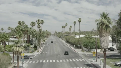 Aerial pushes along a stretch of E Palm Canyon Dr in Palm Springs, California Stock-Footage 156032619