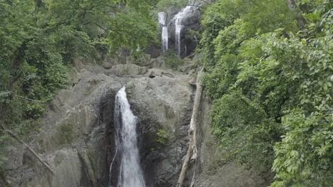 Aerial pushes up the higher levels of Argyle Falls in Tobago on a sunny day Stock Footage 340851599
