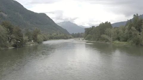 Aerial pushes low over the Skagit River towards North Cascades National Park Stock Footage 345182525