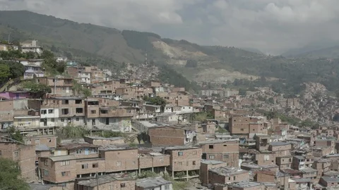 Aerial pushes over hillside of Comuna 13 neighborhood towards mountains Vídeos de archivo 105628683