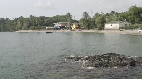 Aerial pushes over Mt Irvine Bay towards Anchor Bar in Tobago Stock Footage 340855497
