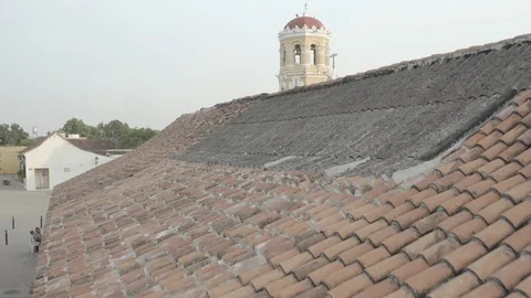 Aerial pushes over red shingle rooftop to main church in Mompox, Colombia Stock-Footage 108725066