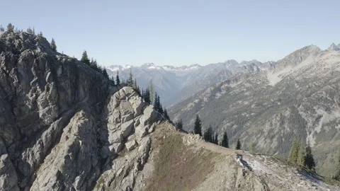 Aerial pushes over the top of Maple Pass to reveal North Cascades mountain range Stock Footage 345177144