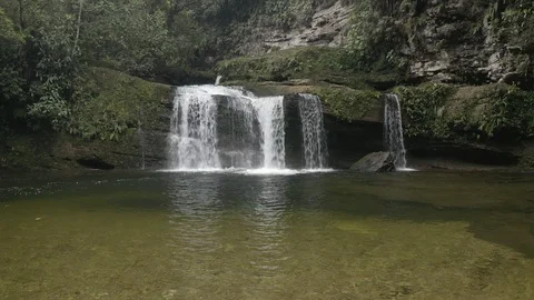 Aerial pushes slowly over the second waterfall on the Fin del Mundo hike 스톡 동영상 104872731