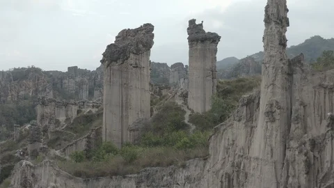 Aerial pushes through two pillars and into the Los Estoraques park in Colombia Stock-Footage 127942628