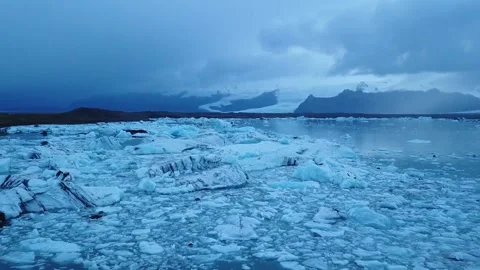 Aerial pushing back overlooking beautiful icy ocean and glaciers Stock Footage 160810226