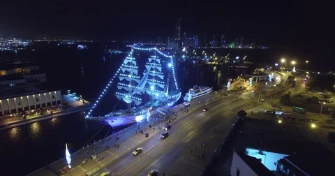 Aerial pushing over illuminated ship at night towards skyline of Bocagrande Stock-Footage 72358366