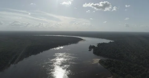 Aerial pushing slowly forward over the Inirida river at sunset Stock Footage 100669335