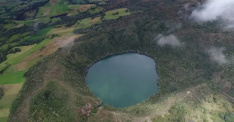 Aerial pushing towards and tilting down above the Laguna de Guatavita Stock Footage