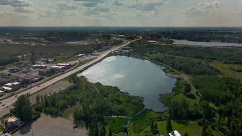 Aerial pushing towards open pit mine with city in foreground. Stock Footage 254908808