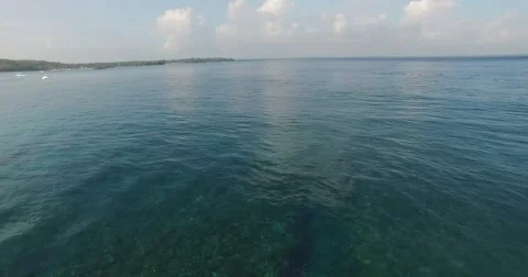 AERIAL quick pan left to right of ocean waves in Nusa lembongan, Bali Stock Footage 59881901