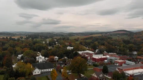 Aerial of Quiet Quaint Town with Beautiful Foliage and Mountain Landscape Stock Footage 141061853